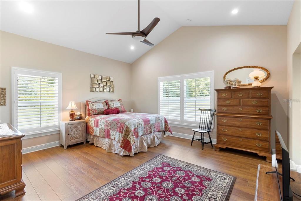 700 Old Geneva Road Geneva, FL 32732 - Photo 18 of 79 a bedroom with a bed and a chandelier