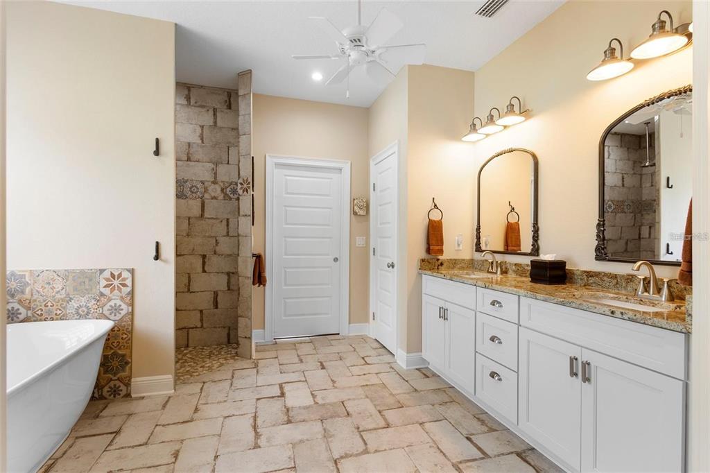 700 Old Geneva Road Geneva, FL 32732 - Photo 25 of 79 a spacious bathroom with a granite countertop sink mirror and bathtub