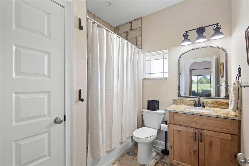 700 Old Geneva Road Geneva, FL 32732 - Photo 41 of 79 a bathroom with a toilet a sink and a mirror
