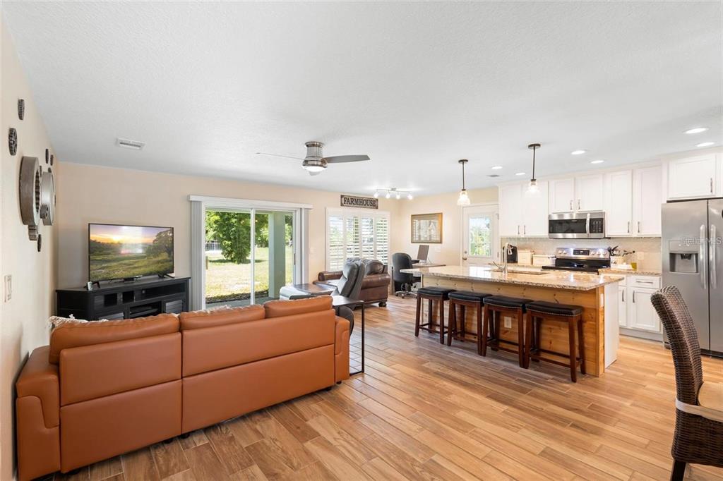 700 Old Geneva Road Geneva, FL 32732 - Photo 47 of 79 a living room with furniture kitchen view and a flat screen tv