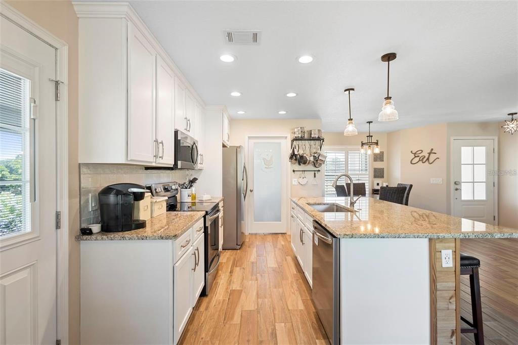 700 Old Geneva Road Geneva, FL 32732 - Photo 50 of 79 a kitchen with stainless steel appliances granite countertop a sink stove and refrigerator