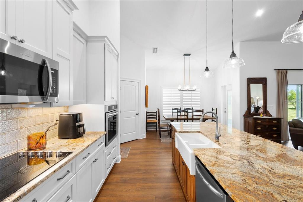700 Old Geneva Road Geneva, FL 32732 - Photo 10 of 79 a large kitchen with kitchen island white cabinets and stainless steel appliances