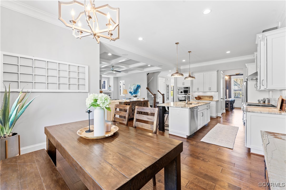 2437 Mitchells Mill Drive Midlothian, VA 23112 - Photo 21 of 50 a kitchen with stainless steel appliances kitchen island granite countertop a table chairs in it and wooden floors