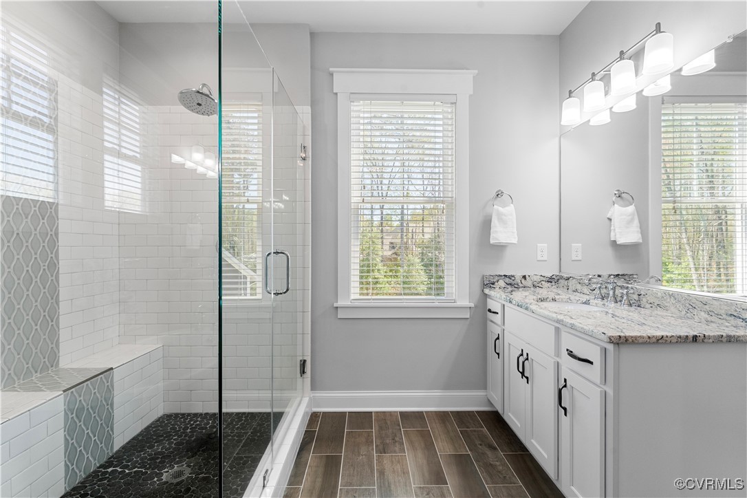2437 Mitchells Mill Drive Midlothian, VA 23112 - Photo 29 of 50 a bathroom with a granite countertop sink a toilet a shower and a mirror