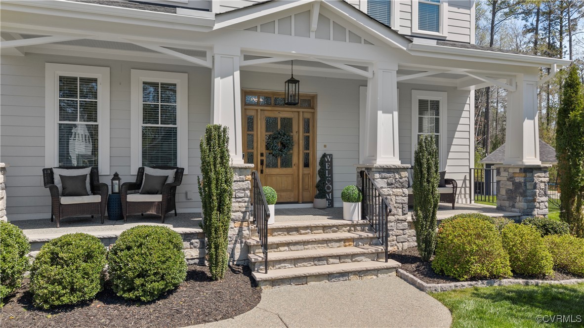 2437 Mitchells Mill Drive Midlothian, VA 23112 - Photo 4 of 50 front view of a building with potted plants