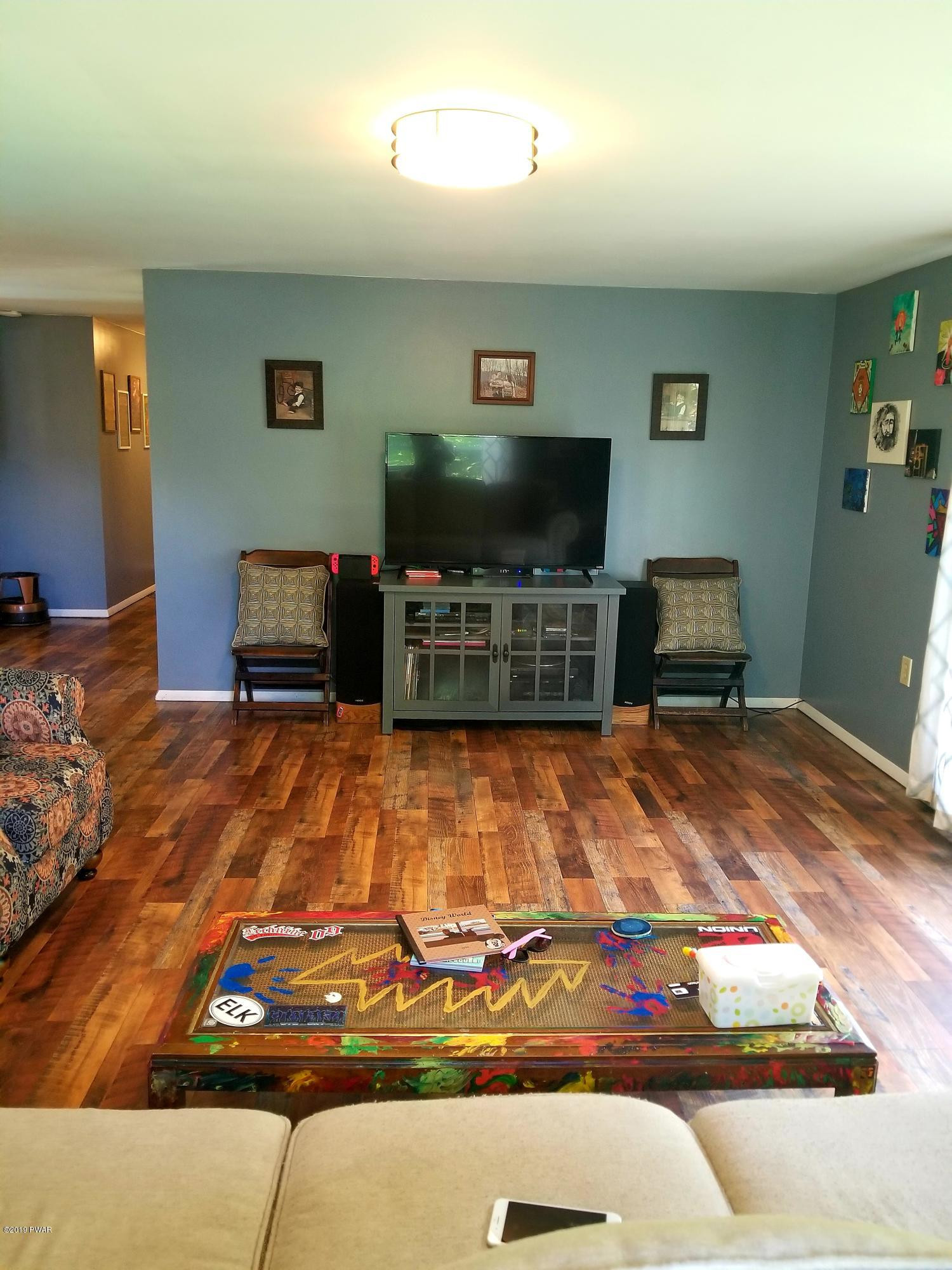 144 Mid Valley Road Lake Ariel, PA 18436 - Photo 24 of 55 a room with wooden floor and furniture