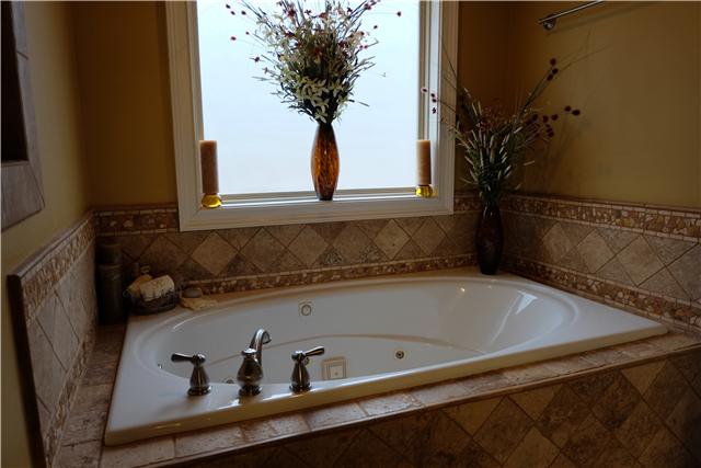 131 Ridgebend Drive Murfreesboro, TN 37128 - Photo 12 of 20 Whirlpool tub and custom tiled shower with glass door give a spa-like atmosphere to the master suite.