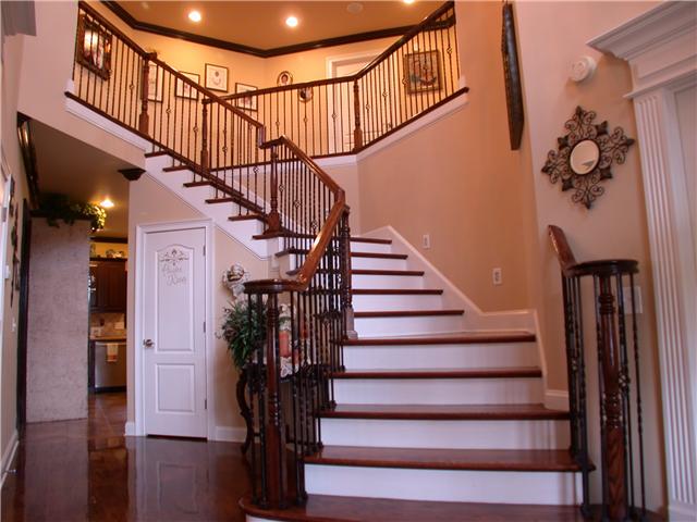 131 Ridgebend Drive Murfreesboro, TN 37128 - Photo 3 of 20 Upon entrance, you are met with a lavish winding staircase with hardwood treads. Step lighting is one of many detail features in this lovely home. Wrought iron chandelier with medallion hangs from the two story foyer. A high level of trim and more.