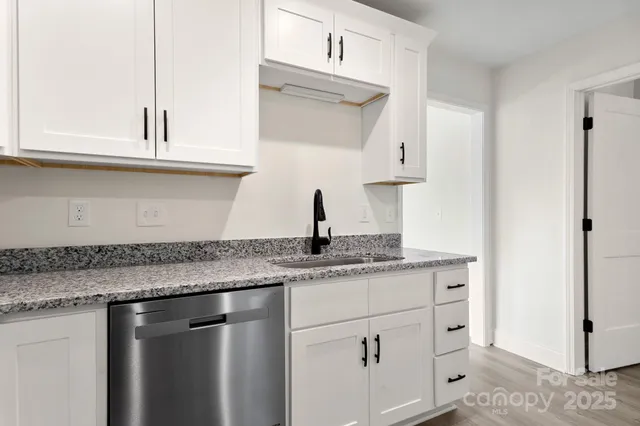 a kitchen with stainless steel appliances granite countertop a sink and a cabinets