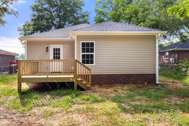a view of a house with a yard and sitting area