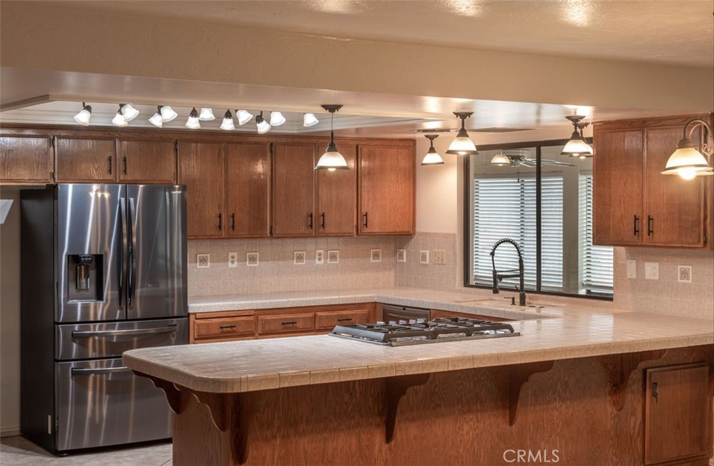 14760 Keota Road Apple Valley, CA 92307 - Photo 13 of 34 a kitchen with kitchen island a sink stove and refrigerator