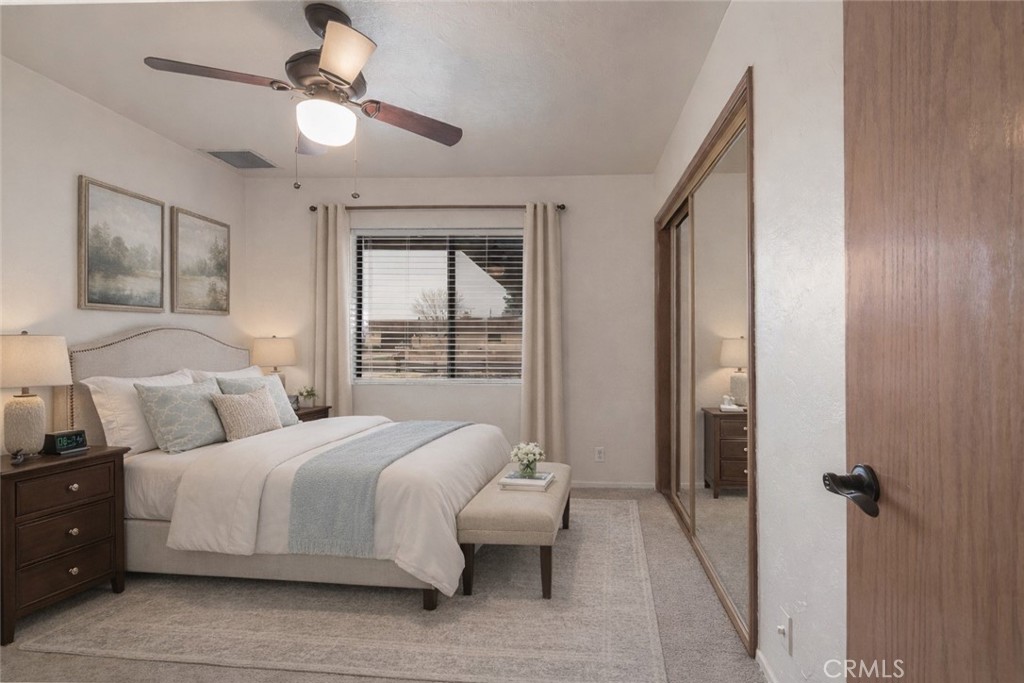 14760 Keota Road Apple Valley, CA 92307 - Photo 18 of 34 a bedroom with a large bed and a chandelier