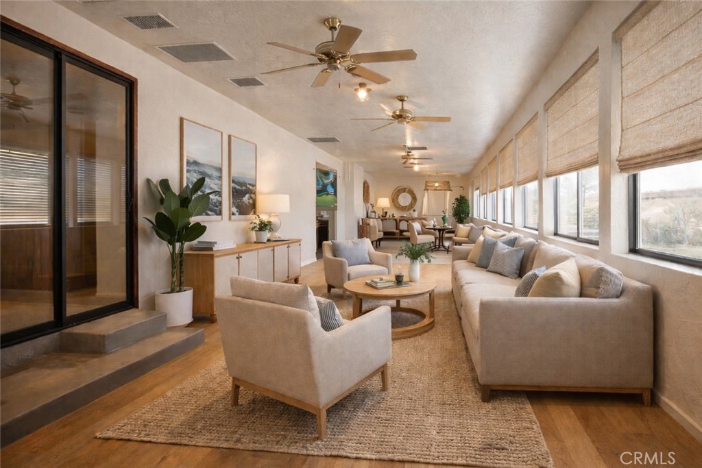 14760 Keota Road Apple Valley, CA 92307 - Photo 22 of 34 a living room with furniture potted plant and a large window