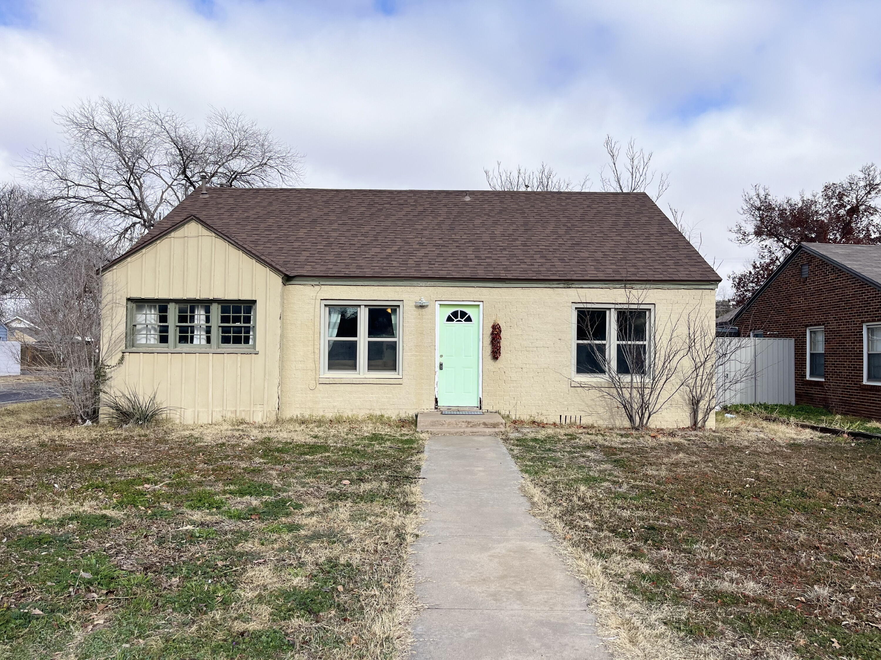 1724 28th Street Lubbock, TX 79411 - Photo 1 of 26 a front view of a house with a garden