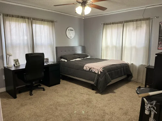 a bedroom with a bed and a chandelier