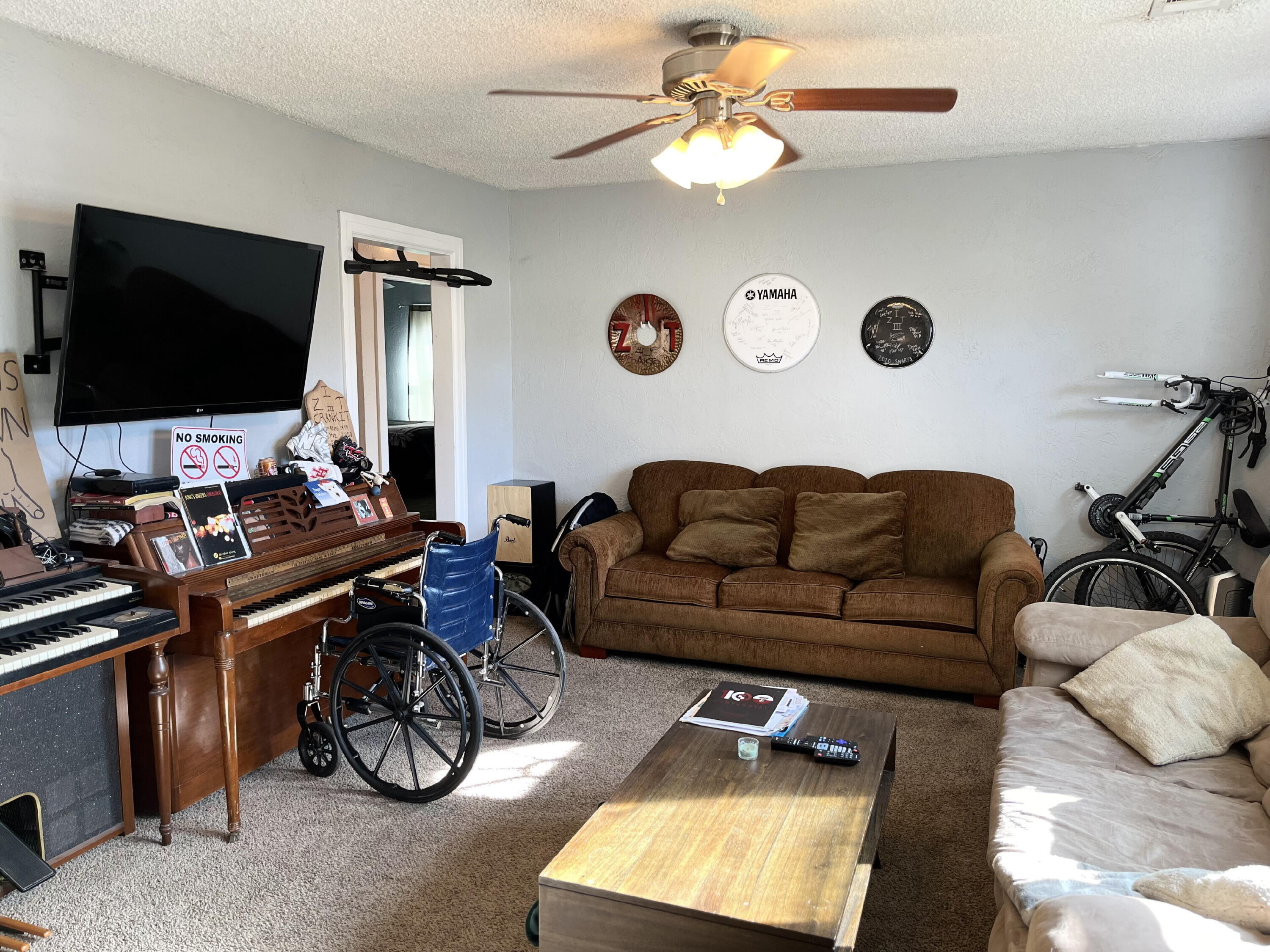1724 28th Street Lubbock, TX 79411 - Photo 2 of 25 a living room with furniture a flat screen tv and a window