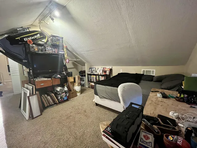 a living room with furniture a fireplace and a wall painting