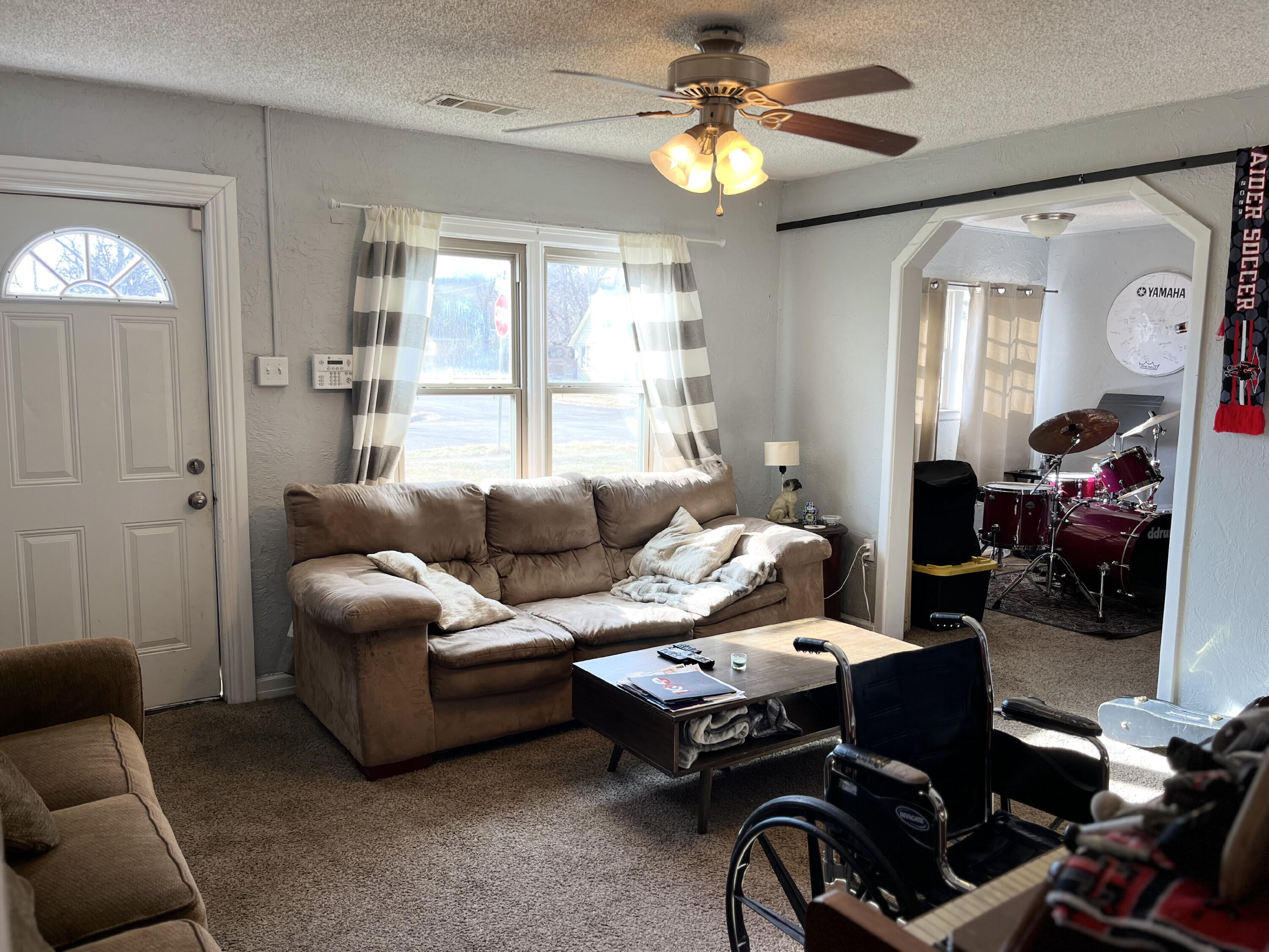 1724 28th Street Lubbock, TX 79411 - Photo 3 of 25 a living room with furniture a ceiling fan and a window