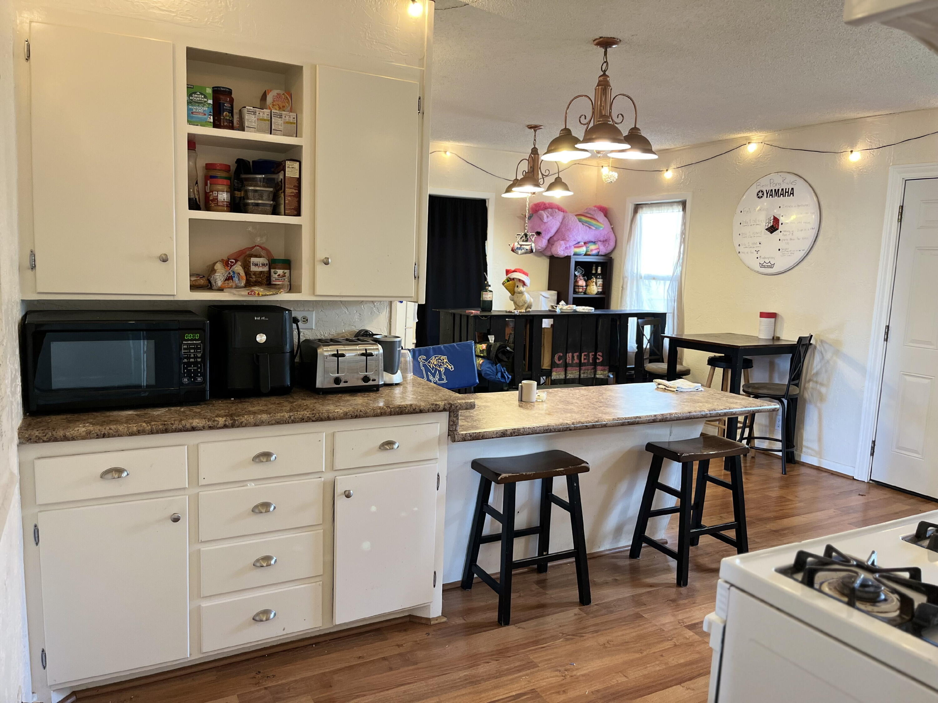 1724 28th Street Lubbock, TX 79411 - Photo 8 of 25 a kitchen with stainless steel appliances granite countertop a stove a sink dishwasher and a dining table with wooden floor