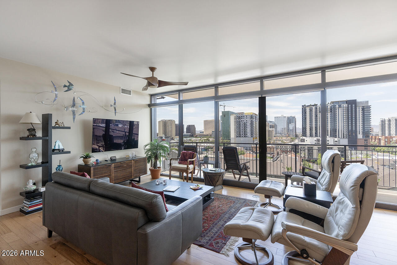 200 West Portland Street, Unit 1113 Phoenix, AZ 85003 - Photo 10 of 85 a living room with furniture a flat screen tv and a large window