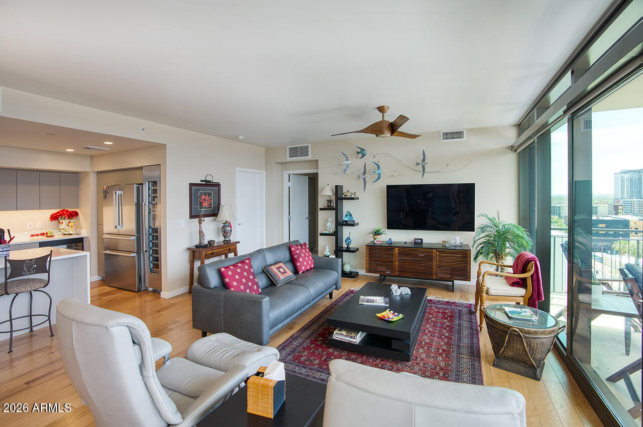 200 West Portland Street, Unit 1113 Phoenix, AZ 85003 - Photo 12 of 85 a living room with furniture a flat screen tv and a large window