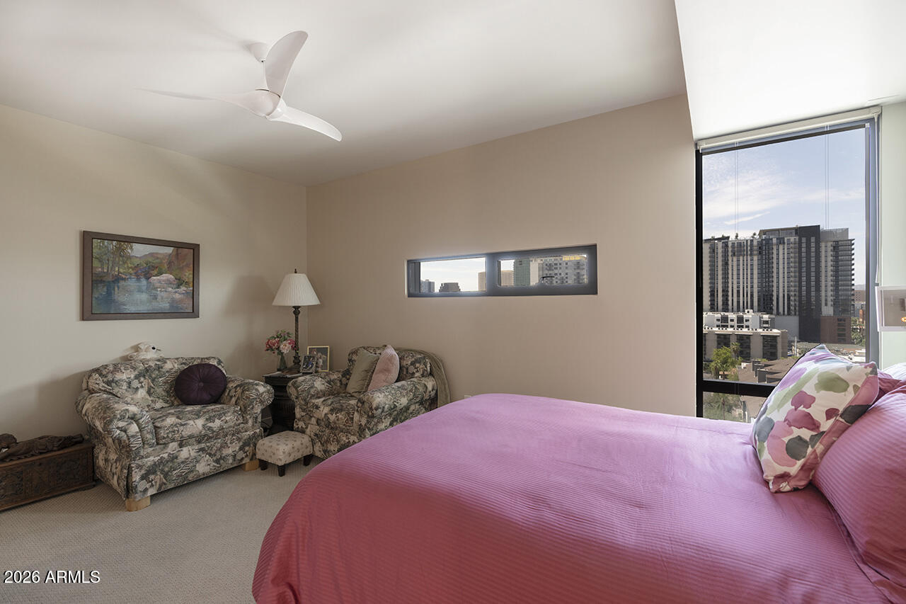 200 West Portland Street, Unit 1113 Phoenix, AZ 85003 - Photo 19 of 85 a bedroom with bed and a chandelier