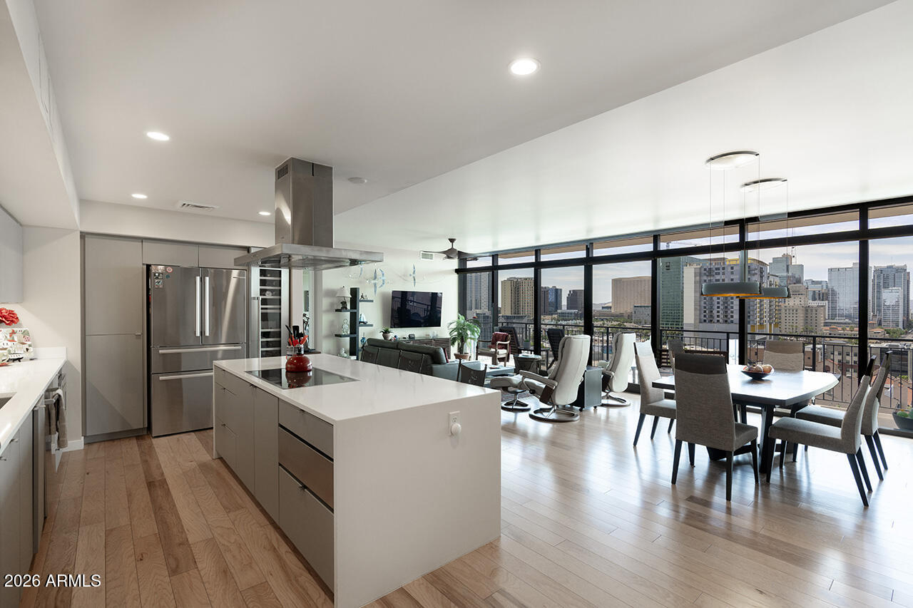 200 West Portland Street, Unit 1113 Phoenix, AZ 85003 - Photo 3 of 85 a kitchen with a stove a refrigerator and chairs