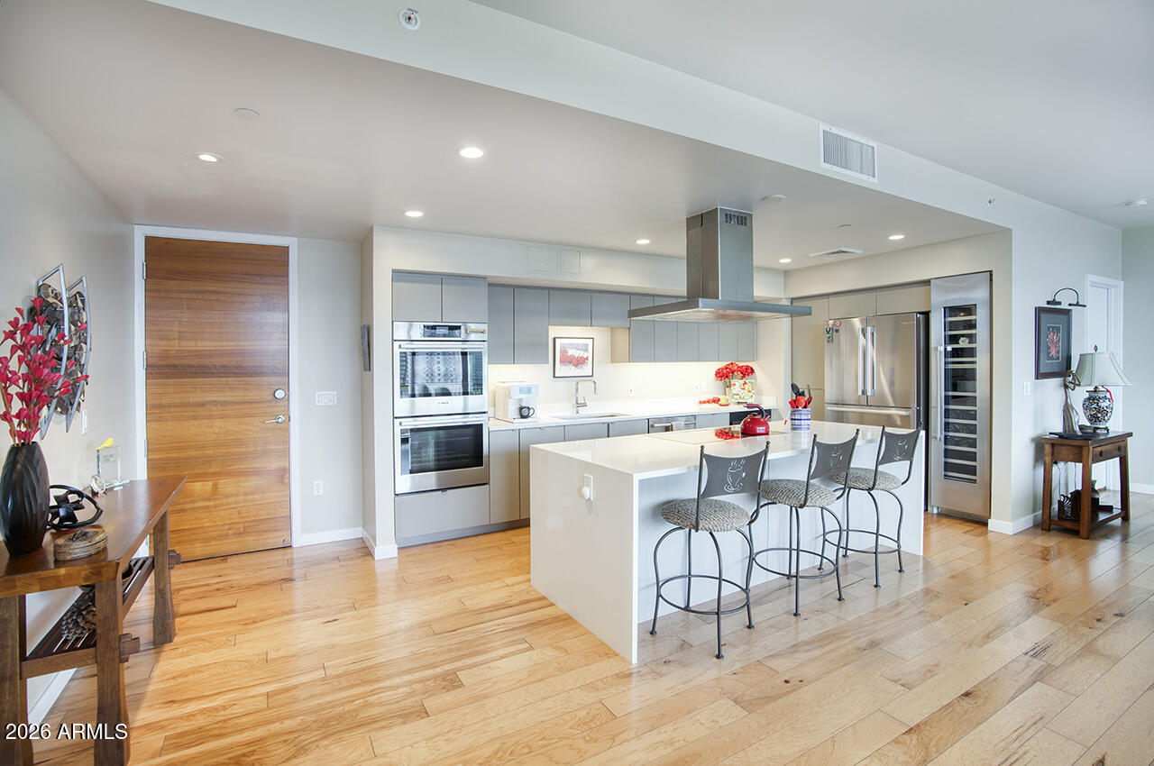200 West Portland Street, Unit 1113 Phoenix, AZ 85003 - Photo 4 of 85 a kitchen with stainless steel appliances kitchen island granite countertop a refrigerator and a stove top oven