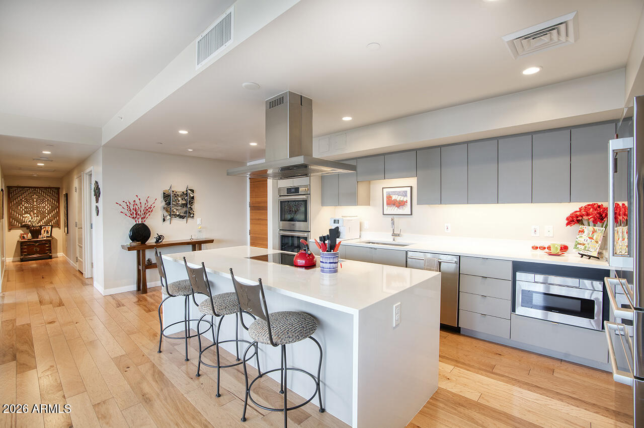 200 West Portland Street, Unit 1113 Phoenix, AZ 85003 - Photo 6 of 85 a kitchen with a sink cabinets and wooden floor