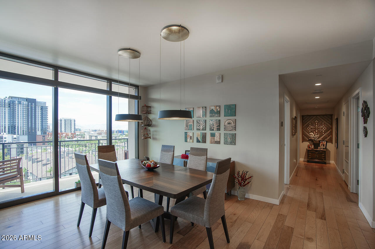 200 West Portland Street, Unit 1113 Phoenix, AZ 85003 - Photo 8 of 85 a view of a dining room with furniture and wooden floor