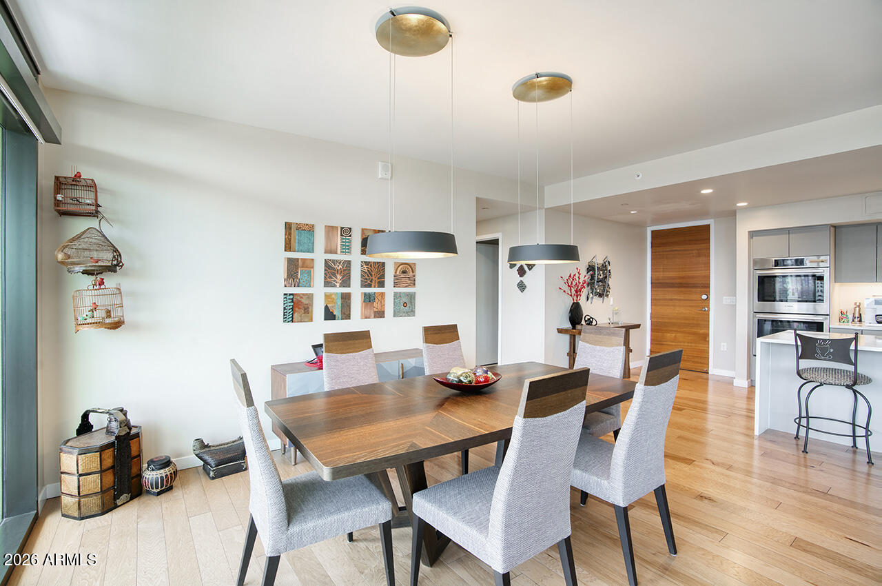 200 West Portland Street, Unit 1113 Phoenix, AZ 85003 - Photo 9 of 85 a dining room with furniture and wooden floor