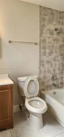 a white toilet sitting next to a bathroom sink