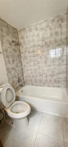 a bathroom with a toilet and a bathtub