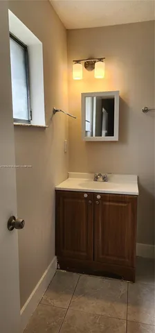 a bathroom with a sink vanity and mirror