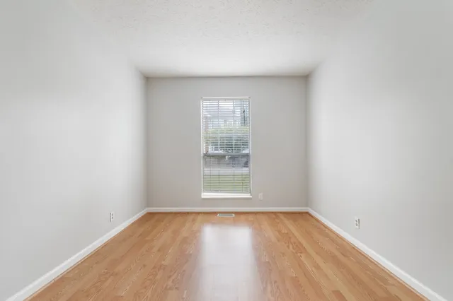 a view of a room with wooden floor