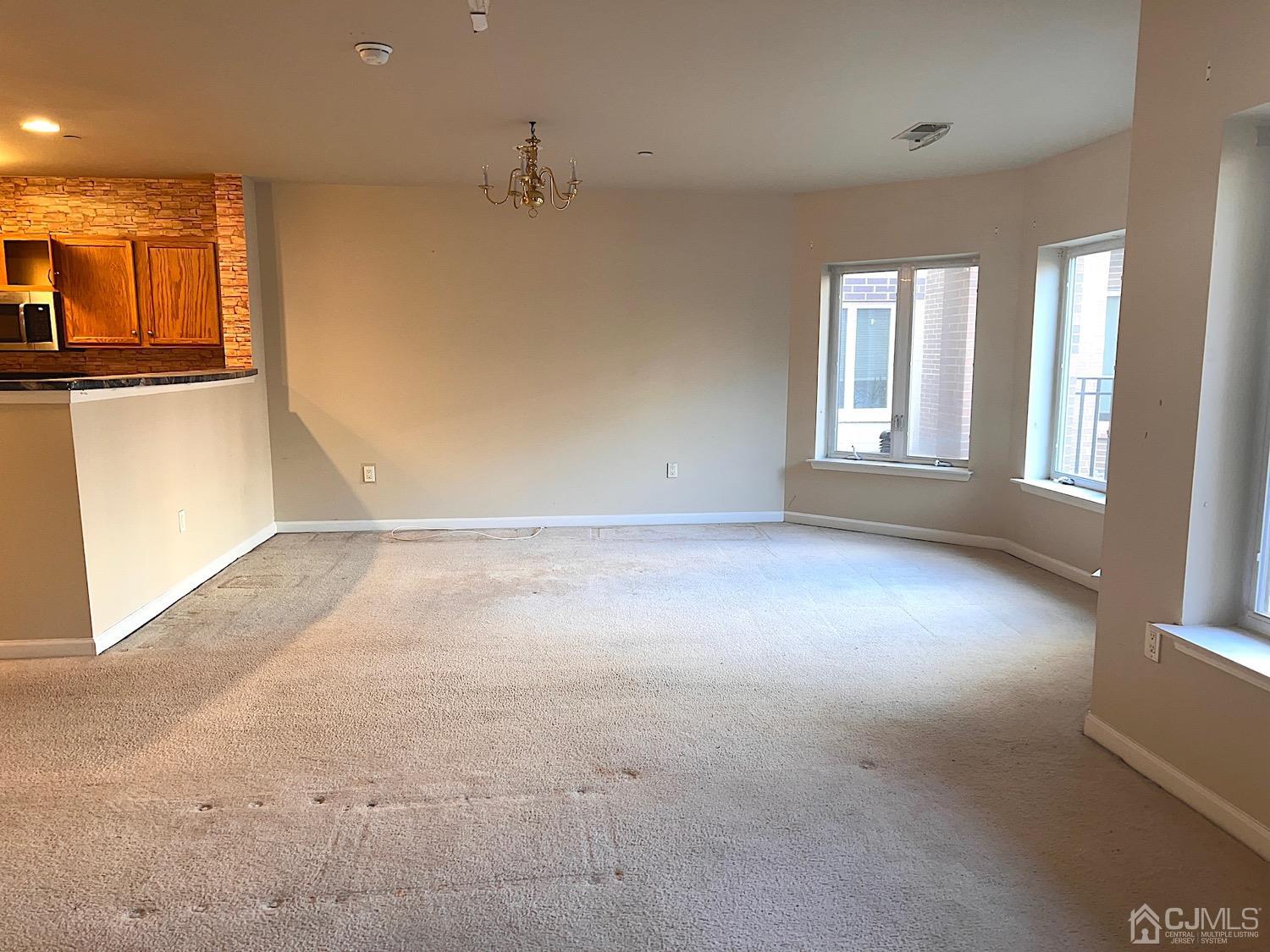 368 Rector Street, Unit 317 Perth Amboy, NJ 08861 - Photo 3 of 25 Dining room area with chandelier and many large windows offering plenty of natural light.