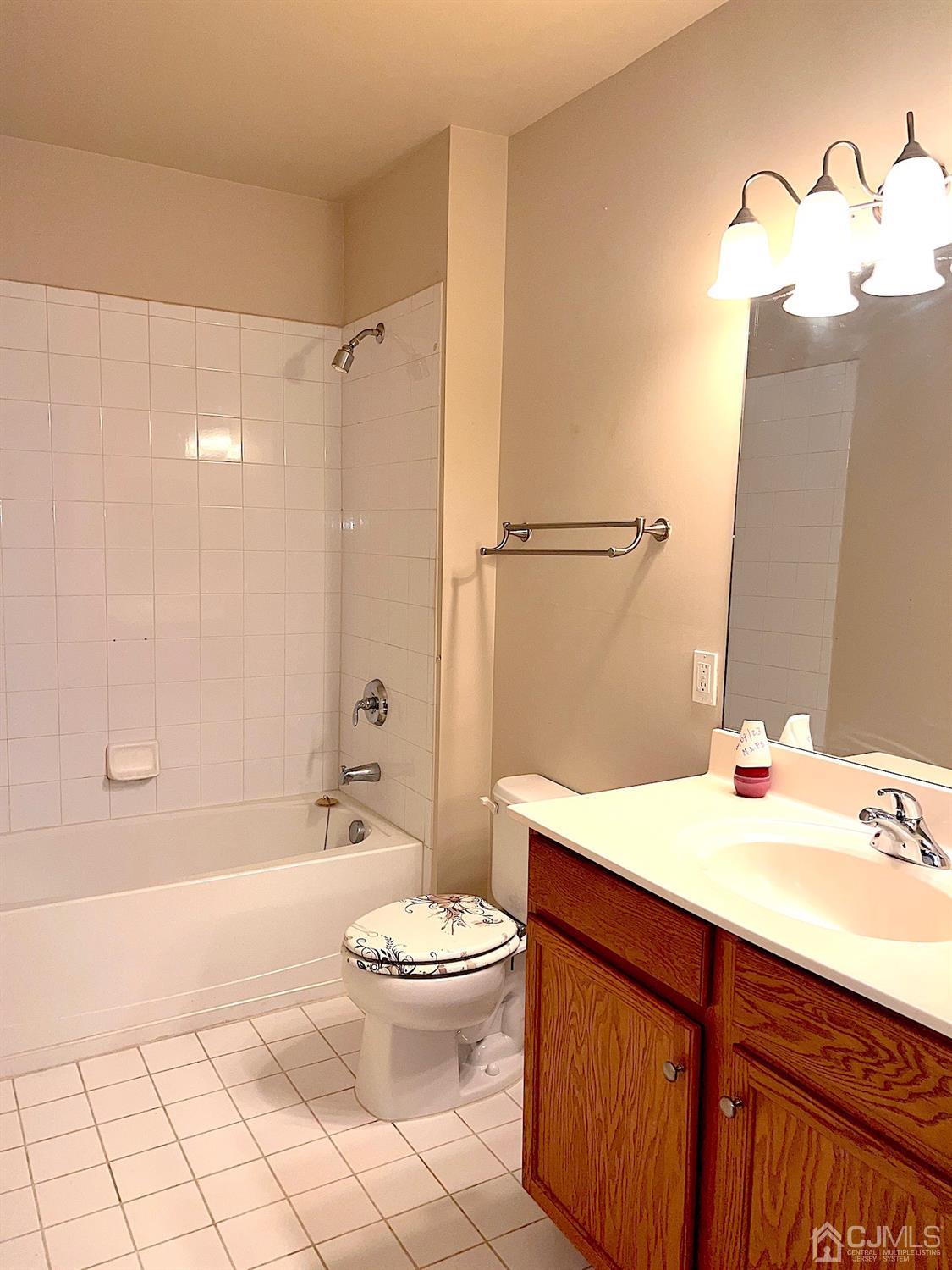 368 Rector Street, Unit 317 Perth Amboy, NJ 08861 - Photo 8 of 25 Main bathroom: Tiled floor and tile wall shower. Oak vanity with triple lighting.