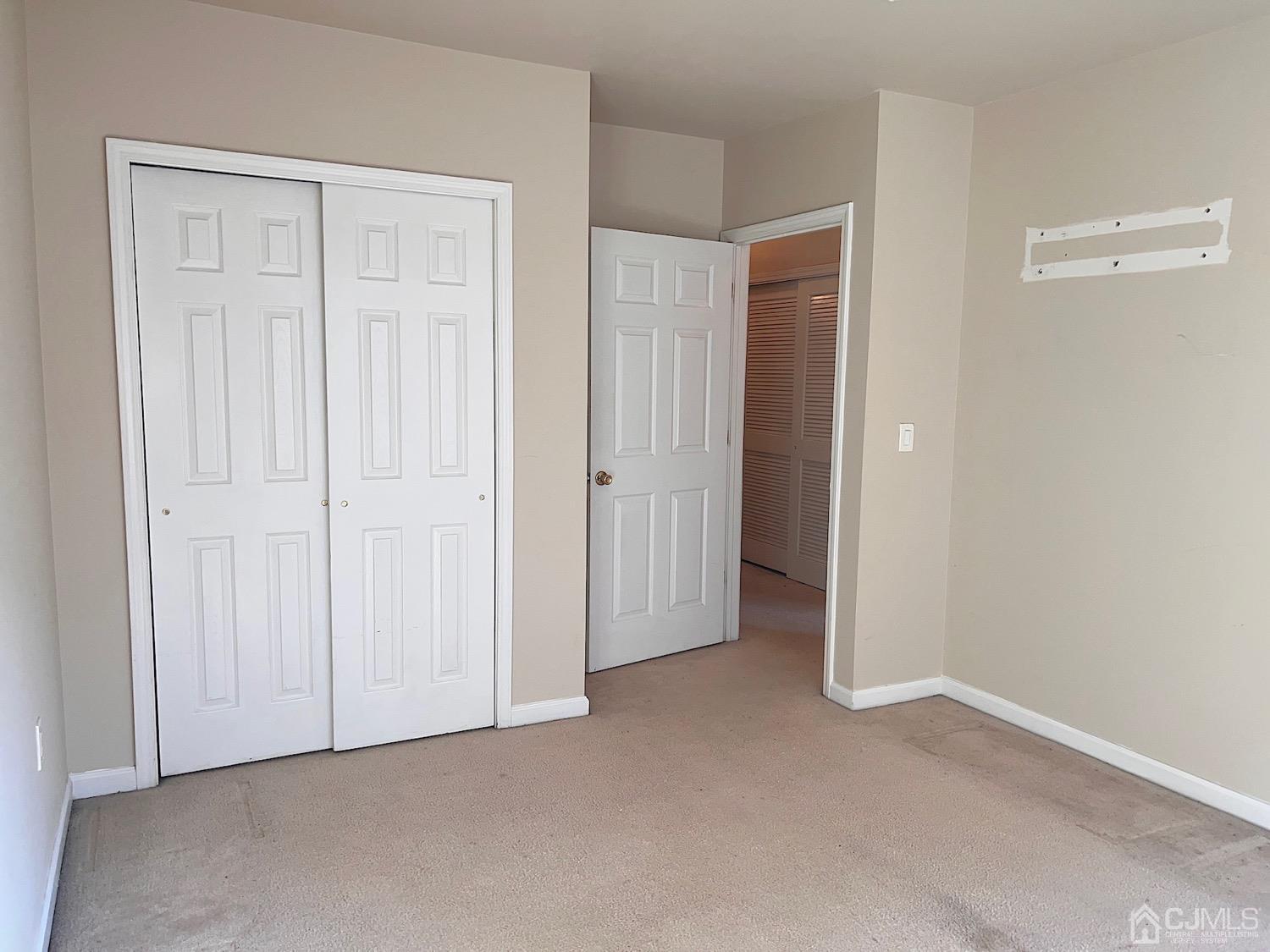 368 Rector Street, Unit 317 Perth Amboy, NJ 08861 - Photo 10 of 25 Bedroom 2 view 2: Neutral decor, view of closet area and access.