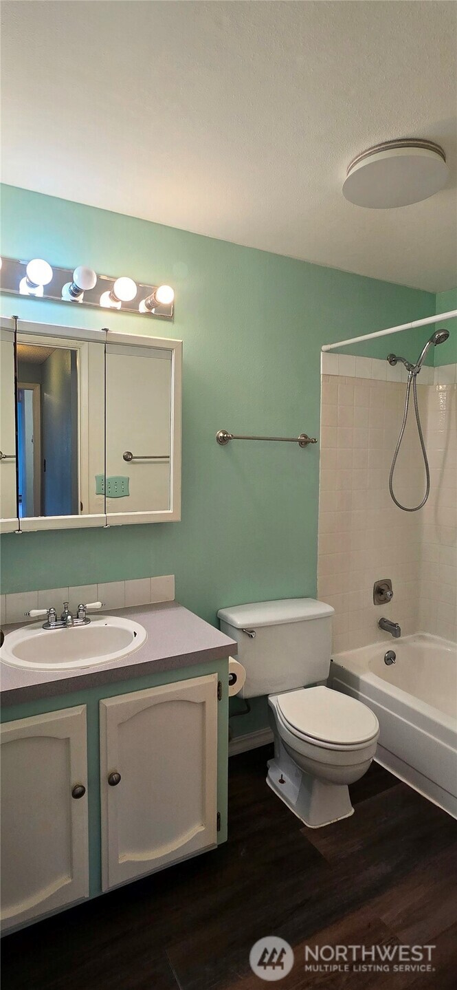 820 Cady Road, Unit H304 Everett, WA 98203 - Photo 13 of 28 a bathroom with a granite countertop toilet sink and mirror