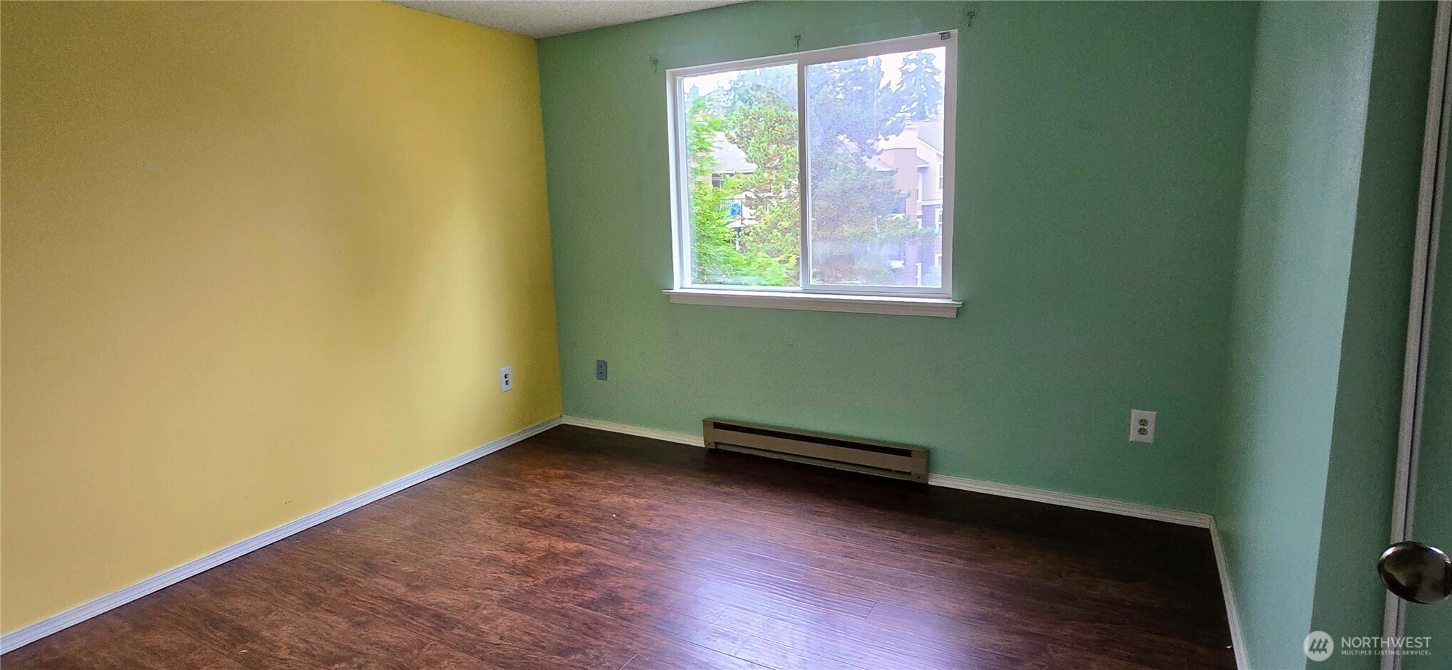 820 Cady Road, Unit H304 Everett, WA 98203 - Photo 15 of 28 an empty room with wooden floor and windows