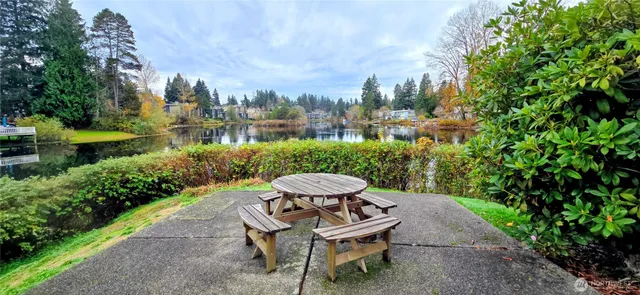 a view of a patio with furniture and a garden