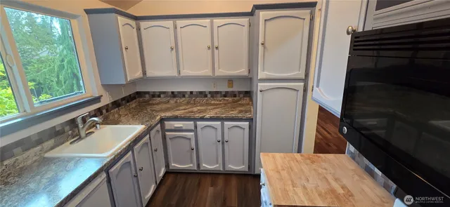 a bathroom with a sink a mirror and shower