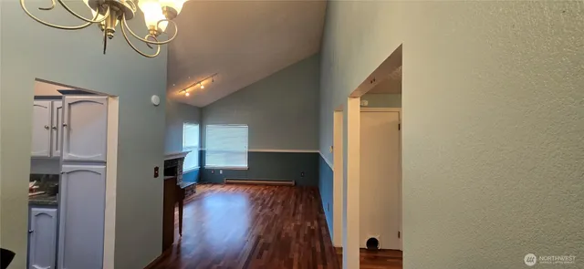 a view of entryway and hall with wooden floor