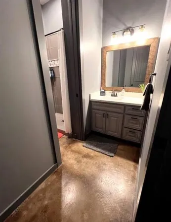 a bathroom with a sink a mirror and a vanity