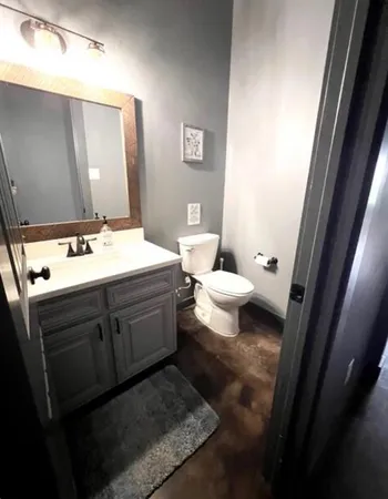 a bathroom with a sink toilet and mirror