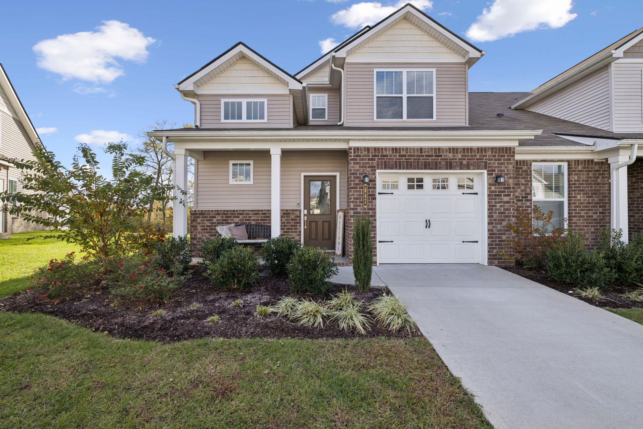 647 Birdie Drive Spring Hill, TN 37174 - Photo 1 of 15 a front view of a house with a yard and garage