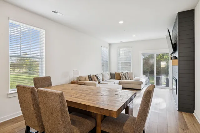 a dining room with furniture and wooden floor