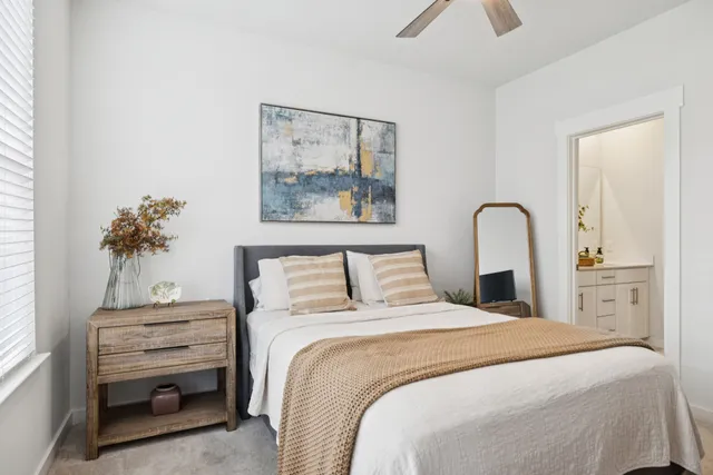 a bedroom with a bed and a painting on the wall