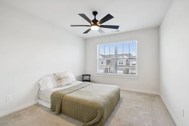 a bedroom with a bed and window