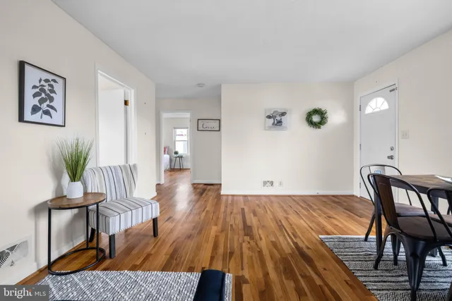 a view of a room with furniture and wooden floor